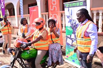 Minister for Science, Technology, and Innovation Dr. Monica Musenero Masanza pictured trying out the Zembo electric bike a new Tier in the SafeBoda App while SafeBoda co-founder; Ricky Rapa Thomson (right) looks on. COURTESY PHOTO / SafeBoda