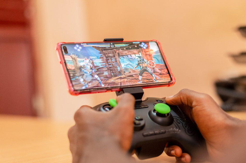 A person pictured playing a game on a smartphone. (PHOTO: Katende Erick and Blaise Wayinda)