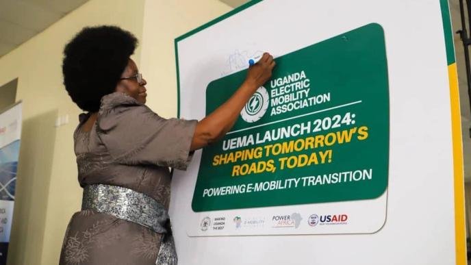 Dr. Monica Musenero Masanza, Minister for Science, Technology, and Innovation signing on a pluckcard after launching the Uganda Electric Mobility Association (UEMA). Courtesy Photo