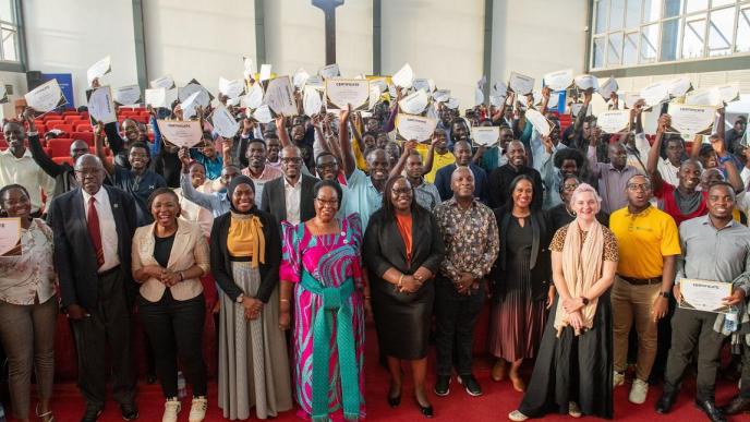 Minister of State for ICT and National Guidance, Joyce Ssebugwawo (In a gomesi), executives from private sector players including MTN Uganda, celebrates with the inaugural MTN ACE Program graduates at the National ICT Hub in Nakawa, September 7, 2023.