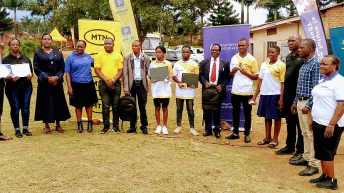 MTN Uganda and MTN Foundation staff pose for a group photo with the best performed graduands from Eastern Uganda in MTN's Digital Literacy Program. The best performing graduands were given laptops and internet. Courtesy Photo