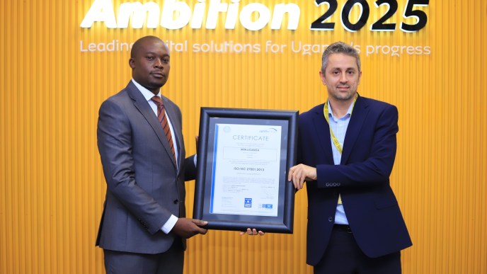 MTN Uganda Chief Technology and Information Officer, Ali Monzer (right) receiving International Standards Certifications – ISO 27001 on Information Security Management Systems certification on behalf of MTN Uganda.