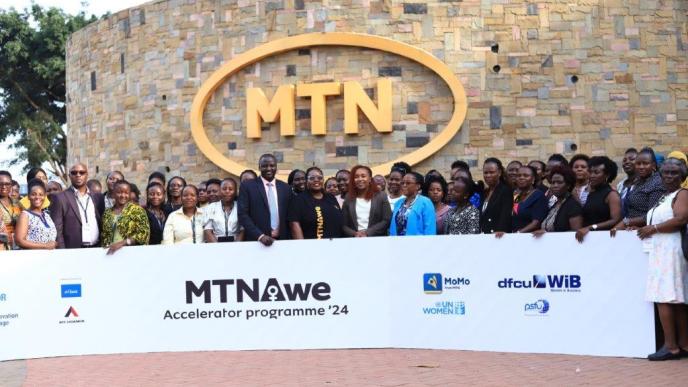 MTN Uganda CEO, Sylvia Mulinge with telco's partners of the AWE Program DFCU Bank, PSFU, NSSF, ATC, UN Women, The Innovation Village, and MTN Mobile Money (U) Limited pose for a group photo with women entrepreneurs selected as service providers under the AWE program.