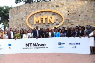 MTN Uganda CEO, Sylvia Mulinge with telco's partners of the AWE Program DFCU Bank, PSFU, NSSF, ATC, UN Women, The Innovation Village, and MTN Mobile Money (U) Limited pose for a group photo with women entrepreneurs selected as service providers under the AWE program.