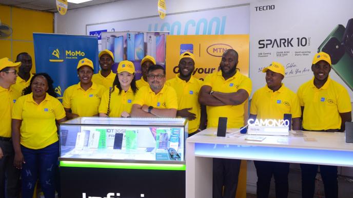 MTN Uganda and TakeNow teams pose for a group photo after annoucing their partnership, unveiling new phones on the Mpola Mpola payment scheme.