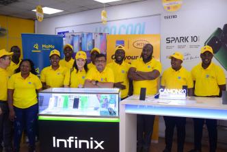 MTN Uganda and TakeNow teams pose for a group photo after annoucing their partnership, unveiling new phones on the Mpola Mpola payment scheme.