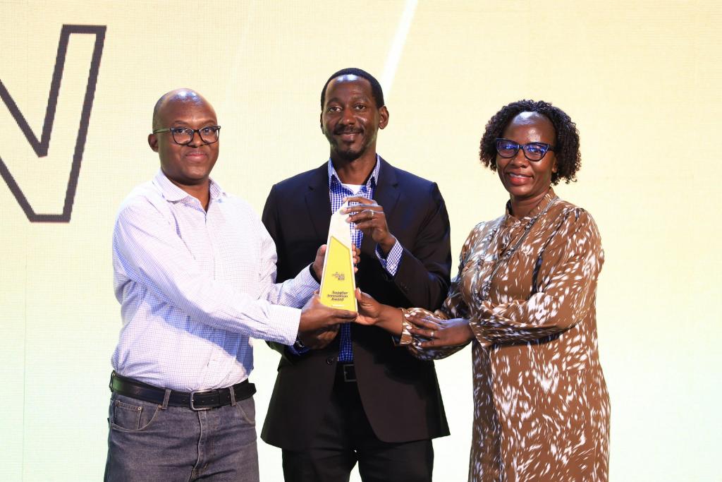 MTN's GM Capital Projects, Nicholas Beijuka (L) hands over an Innovation Award to the Ericcson Team.