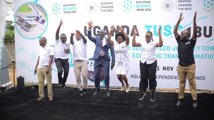 Hon. Dr. Monica Musenero Masanza (3rd from right), the Minister for Science, Technology & Innovation with other officials and partners jump as they launch the 2023 National Science week set to happen from 6-11, November.