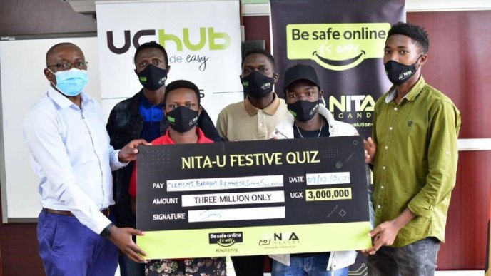 Kenneth Kasasira, Ndyamuhaki Barham, Mugisha Simon, Ajo Clement, and Mugenyi Suleiman, winners of the second quiz receiving a dummy cheque of UGX3,000,000.