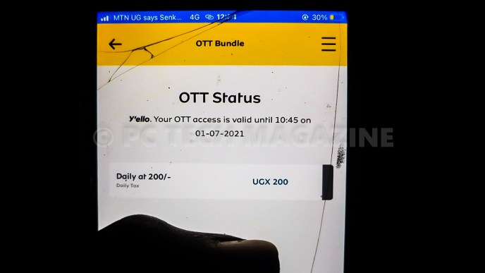 A silhouette photo of a user checking their OTT tax validation. (PHOTO: Olupot Nathan Ernest/PC Tech Magazine)