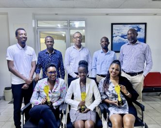 Part of the Media Age team pose for a group photo with the agency's won accolades. PHOTO: TBWA Uganda