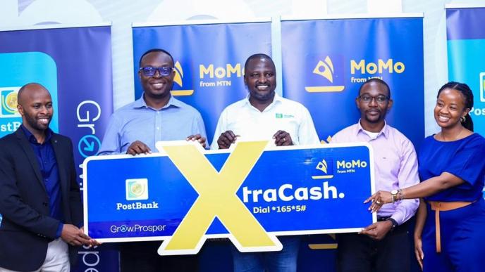 PostBank Uganda and MTN MoMo Uganda officials pose for a group photo after launching, Xtracash, a digital Micro Lending solution that will extend loans to mtn mobile money customers.