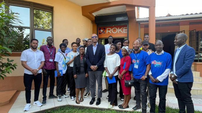 Roger Sekaziga (center in glasses), CEO Roke Telkom Poses for a photo with Jesuit Refugee Service students after they took a tour of Roke Telkom offices. COURTESY PHOTO