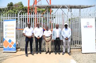 Daniele Nyirandutiye, (C), USAID/Uganda Mission Director, Roger Sekaziga, (2nd L), CEO Roke Telkom, Eng. Mujuni B Arnold, (2nd R), Ag. Head Uganda Communications Universal Service and Access Fund (UCUSAF), Uganda Communications Commission pose for a phot with other Roke Telkom staff member during the official launch of a new telecommunications site in Yumbe, Uganda.