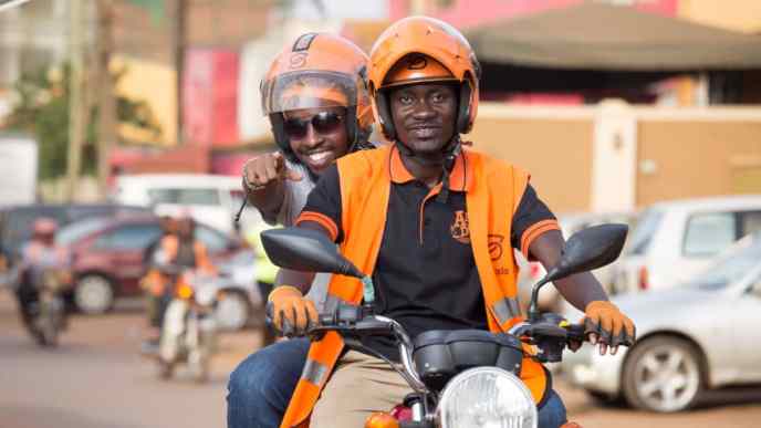 A passenger pictured happy on a Safeboda. FILE PHOTO