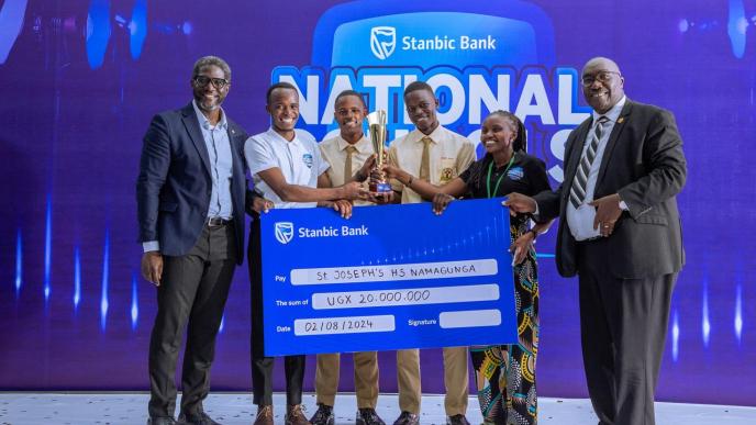 Students of St Josephs High School Namagunga awarded a dummy cheque, and an accolade after emerging as the overall winner of the 9th edition of the Stanbic National Schools’ Championship finals. COURTESY PHOTO