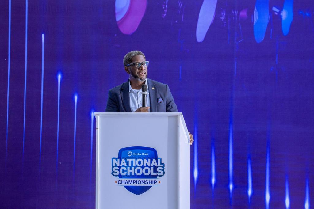 Sam Mwogeza, the Stanbic Bank Executive Director speaking to attendees at the 9th edition of the Stanbic National Schools’ Championship. COURTESY PHOTO