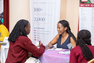 Hairah Kibuuka (center), the Managing Director of Sharz pictured speaking to some students. COURTESY PHOTO