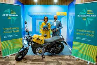 Spiro’s CEO; Kaushik Burman (right) and Kanayo Awani (left) Executive VP of Intra-African Trade and Export Development Bank at Afreximbank pose for a photo after signing a deal that will see Spiro boost sustainable transportation in Africa. The signing was held during the Africa CEO Forum in Kigali, Rwanda. COURTESY PHOTO