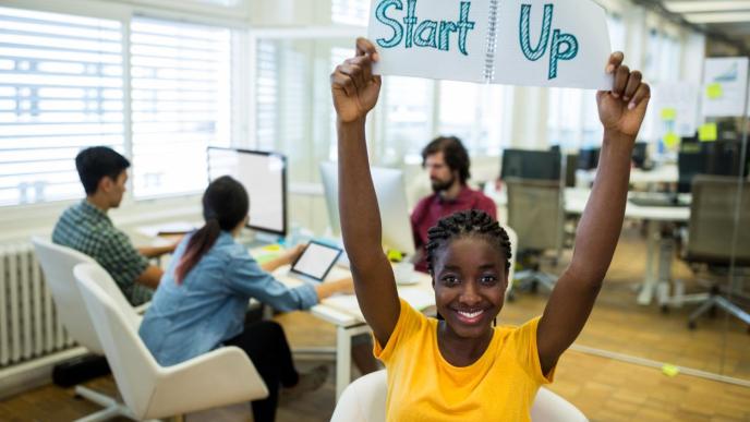 Female entrepreneur holding startup sign. PHOTO: People Creations / Freepik