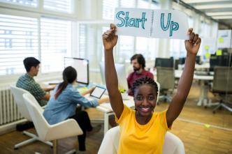 Female entrepreneur holding startup sign. PHOTO: People Creations / Freepik