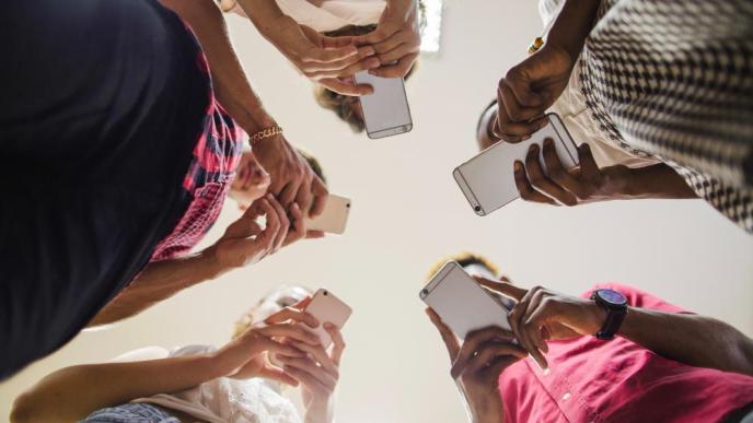 Smartphone Addiction | A group of teens pictured using smartphones. PHOTO: Freepix