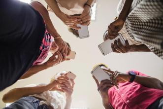 Smartphone Addiction | A group of teens pictured using smartphones. PHOTO: Freepix