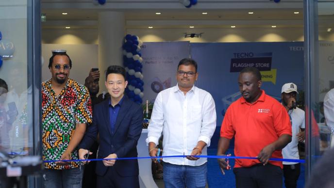 Daniel Lubwama Kigozi also known as Navio (left), and Tecno Mobile Country Director, Timmy Shen (2nd from left) are joined by other guests to cut the ribbion officially opening their first-ever flagship store in Uganda. COURTESY PHOTO / Tecno Uganda