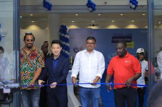 Daniel Lubwama Kigozi also known as Navio (left), and Tecno Mobile Country Director, Timmy Shen (2nd from left) are joined by other guests to cut the ribbion officially opening their first-ever flagship store in Uganda. COURTESY PHOTO / Tecno Uganda