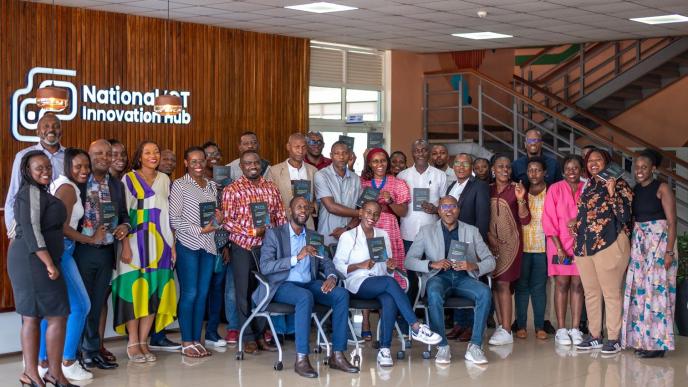 Authors of 'Digital Transformation — The Northstar You Need' Emmanuel Mugabi, Rowena Turinawe, and Osbert Osamai (front row seated) pose for a group photo with attendees after launching their book at the National ICT Innovation Hub in Nakawa. COURTESY PHOTO