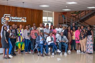 Authors of 'Digital Transformation — The Northstar You Need' Emmanuel Mugabi, Rowena Turinawe, and Osbert Osamai (front row seated) pose for a group photo with attendees after launching their book at the National ICT Innovation Hub in Nakawa. COURTESY PHOTO