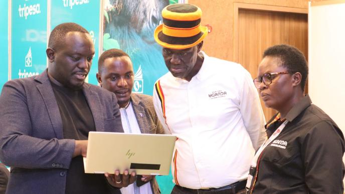 Tripesa CEO, David Gonahasa (left) demonstrates how the platform works to the Buganda Heritage and Tourism Board Executive Director; Albert Kasozi (2nd left) and other guests during the POATE. COURTESY PHOTO/FILE PHOTO