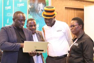 Tripesa CEO, David Gonahasa (left) demonstrates how the platform works to the Buganda Heritage and Tourism Board Executive Director; Albert Kasozi (2nd left) and other guests during the POATE. COURTESY PHOTO/FILE PHOTO