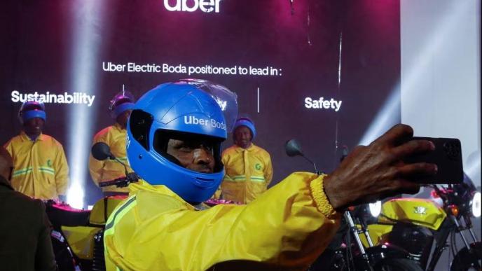 An Uber boda boda rider takes a selfie after the launch of the company's first fleet of electric product in Nairobi, Kenya, August 31, 2023. REUTERS/Monicah Mwangi