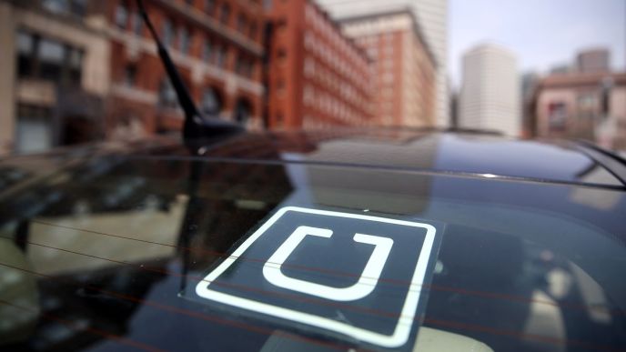 The Uber logo is displayed on the window of a vehicle | File Photo/Curbed Boston via Getty Images.