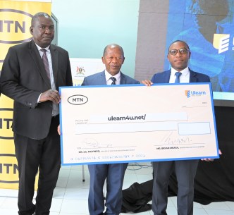 Dr. John Chrysostom Muyingo, the State Minister for Higher Education (Centre Front) and MTN Foundation Senior Manager, Bryan Mbassa (4L) and other officials from the MOES and the Uganda Institute of Information and Communications Technology launches the ULEARN platform on 25 January 2023.