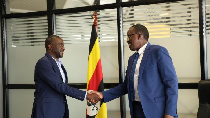 URA Commissioner Gen. John Rujoki Musinguzi (right) and Global Voice Group (GVG) CEO James G. Claude (left) shake hands after their meeting to strategize ways of addressing compliance gaps in the telecom sector and data-dependent companies. Courtesy Photo