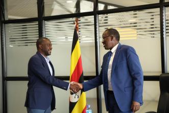 URA Commissioner Gen. John Rujoki Musinguzi (right) and Global Voice Group (GVG) CEO James G. Claude (left) shake hands after their meeting to strategize ways of addressing compliance gaps in the telecom sector and data-dependent companies. Courtesy Photo