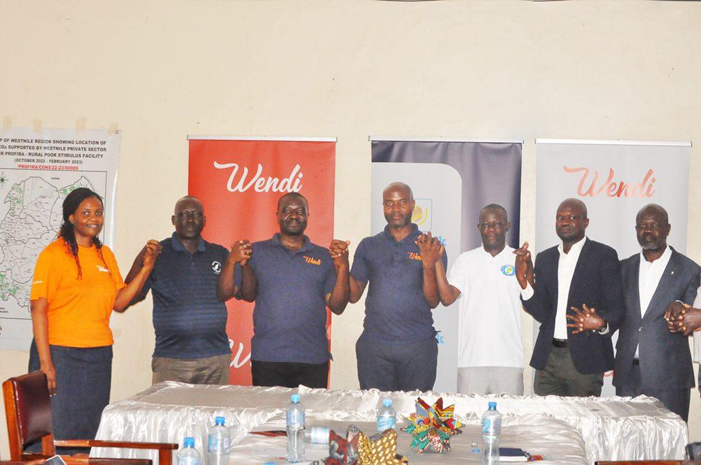 PostBank and WENIPS officials pose for a group photo after announcing their partnership which aims at improving access to financial services to the West Nile community through Village Saving and Loan Associations via the Wendi Mobile Wallet. Courtesy Photo