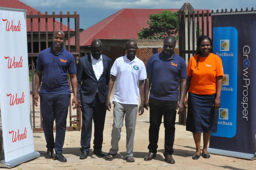 PostBank and WENIPS officials pose for a group photo after announcing their partnership which aims at improving access to financial services to the West Nile community through Village Saving and Loan Associations via the Wendi Mobile Wallet. Courtesy Photo