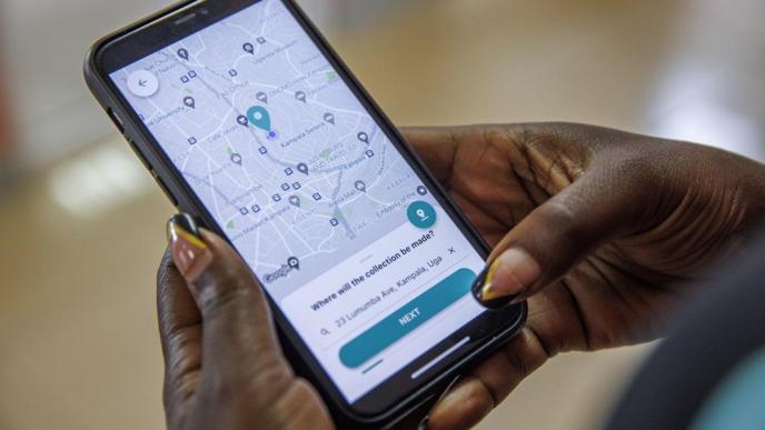 Yo-Waste uses technology to address challenges with official waste management capacity. Pictured, Martin Tumusiime, Yo-Waste founder demostrates how the app works. PHOTO: Luke Dray/GGImages/ProofAfrica