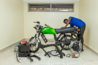 A technician pictured assembling the Zembo e-motorcycle, adding its battery on to it. PHOTO: Zembo