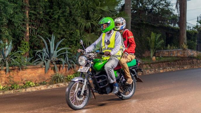 Pictured a rider in Uganda carrying a passenger on an electric motorcycle by Zembo. More than 90% of e-motorcycles sold in sub-Saharan Africa are imported from China and India and are not built for African conditions. (COURTESY PHOTO)