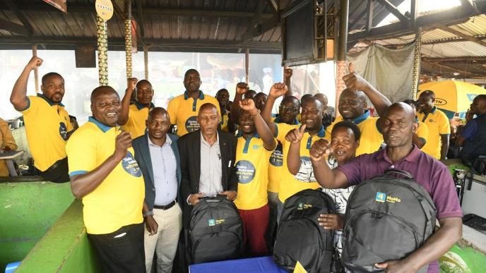 Richard Yego (left), CEO of MTN Mobile Money Uganda Limited with the MTN MoMo team and Nakawa market traders share a moment after the launch of the Zimba Business with MoMo campaign.