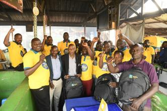 Richard Yego (left), CEO of MTN Mobile Money Uganda Limited with the MTN MoMo team and Nakawa market traders share a moment after the launch of the Zimba Business with MoMo campaign.