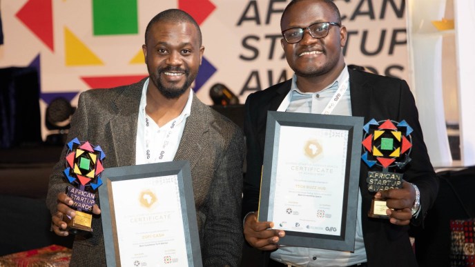 Paul Kirungi (left); founder and CEO of Zofi Cash, and Keneth Twesigye (right), CEO of Tech Buzz Hub pose for a photo with their accolades and certificates after emerging victorious at the 2023 Global Startup Awards Africa held in Addis Ababa, Ethiopia.